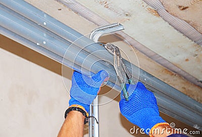 Ð¡onstruction contractor repair house garage door opener system. Stock Photo